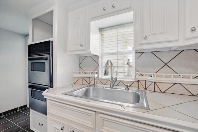 1118 Hammock St, Houston, TX 77009 - kitchen with a sink, white cabinets, light countertops, backsplash, and healthy amount of natural light