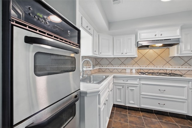 1118 Hammock St, Houston, TX 77009 - kitchen featuring a sink, under cabinet range hood, stainless steel appliances, white cabinetry, and light countertops