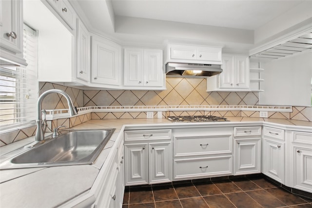 1118 Hammock St, Houston, TX 77009 - kitchen with a sink, under cabinet range hood, stainless steel gas stovetop, white cabinets, and light countertops