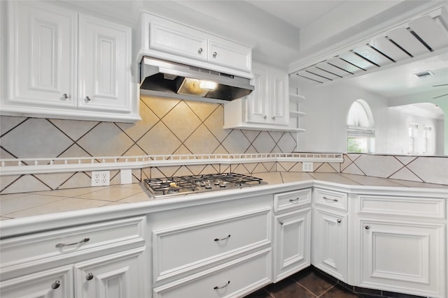 1118 Hammock St, Houston, TX 77009 - kitchen with stainless steel gas stovetop, under cabinet range hood, white cabinets, and light countertops