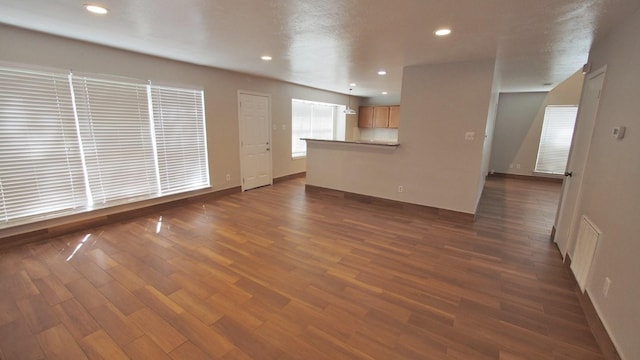 1203 Brook Grove Dr, Katy, TX 77450 - unfurnished living room with baseboards, dark wood-type flooring, and recessed lighting