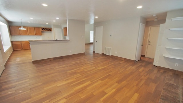 1203 Brook Grove Dr, Katy, TX 77450 - unfurnished living room featuring recessed lighting, light wood finished floors, and baseboards