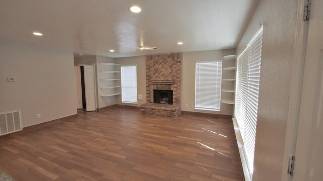1203 Brook Grove Dr, Katy, TX 77450 - unfurnished living room with a fireplace, wood finished floors, baseboards, and recessed lighting