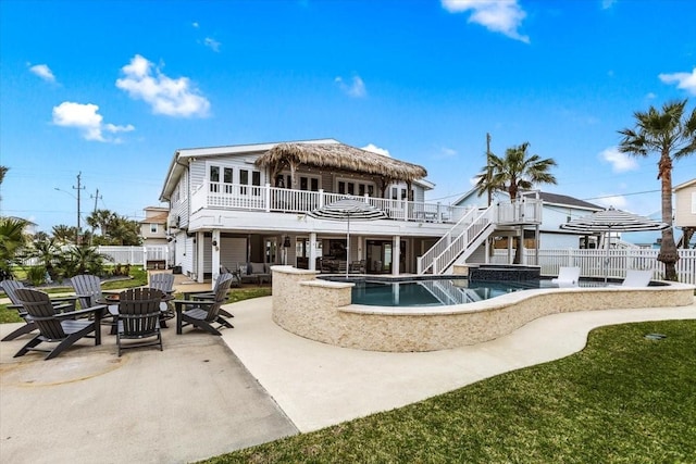 3931 Fort Bend Dr, Galveston, TX 77554 - back of property with a fenced backyard, a patio area, a balcony, and stairway