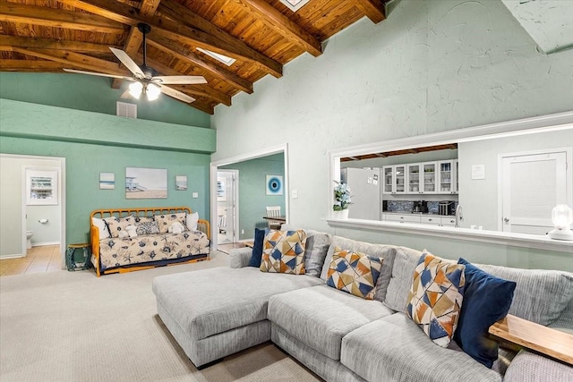 3931 Fort Bend Dr, Galveston, TX 77554 - carpeted living area with wood ceiling with exposed beams, ceiling fan, and high vaulted ceiling