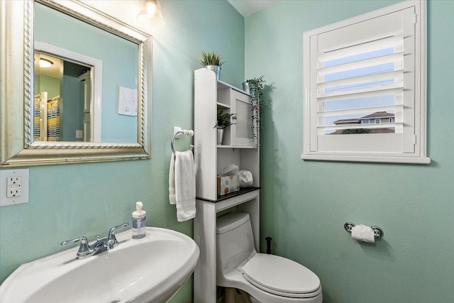 3931 Fort Bend Dr, Galveston, TX 77554 - bathroom featuring a sink and toilet