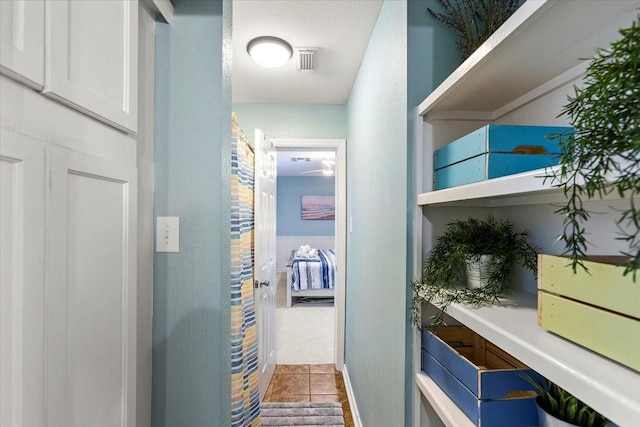 3931 Fort Bend Dr, Galveston, TX 77554 - corridor with a textured wall, tile patterned floors, and carpet flooring