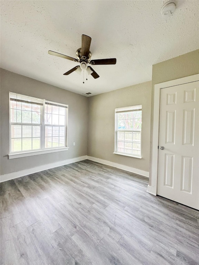 609 Martin Luther King Jr Blvd, Corsicana, TX 75110 - unfurnished room featuring ceiling fan, wood finished floors, a textured ceiling, and baseboards