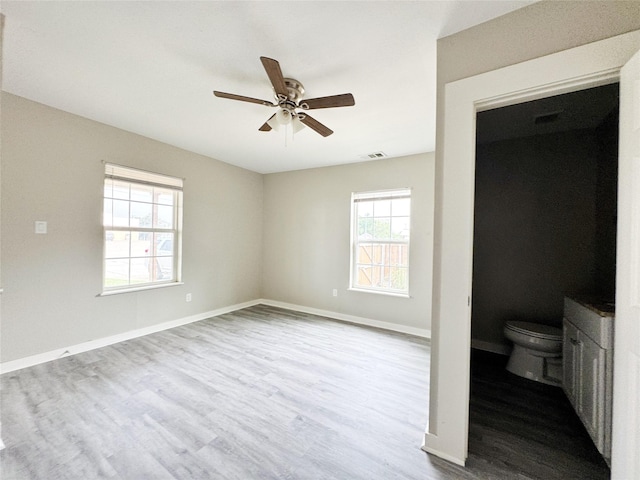 609 Martin Luther King Jr Blvd, Corsicana, TX 75110 - unfurnished bedroom with wood finished floors, baseboards, and a ceiling fan