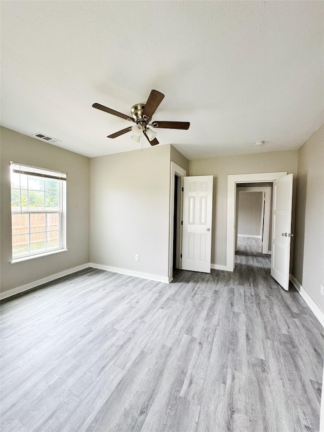 609 Martin Luther King Jr Blvd, Corsicana, TX 75110 - spare room with wood finished floors, a ceiling fan, baseboards, a smoke detector, and a textured ceiling