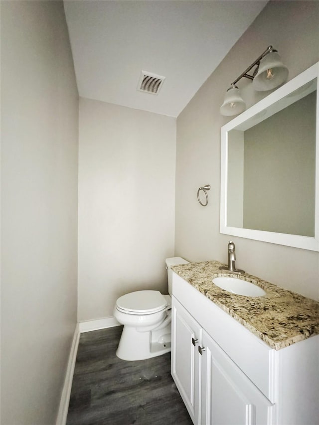609 Martin Luther King Jr Blvd, Corsicana, TX 75110 - bathroom with vanity, wood finished floors, toilet, and baseboards