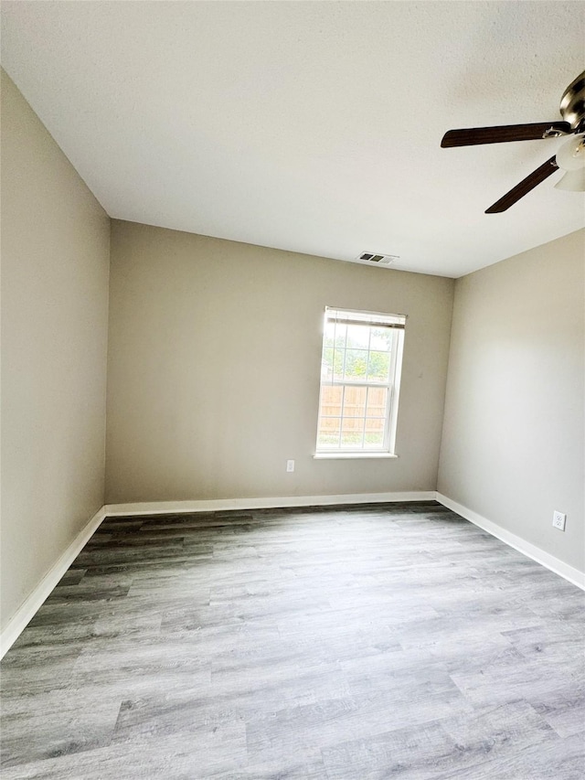 609 Martin Luther King Jr Blvd, Corsicana, TX 75110 - unfurnished room featuring ceiling fan, wood finished floors, and baseboards