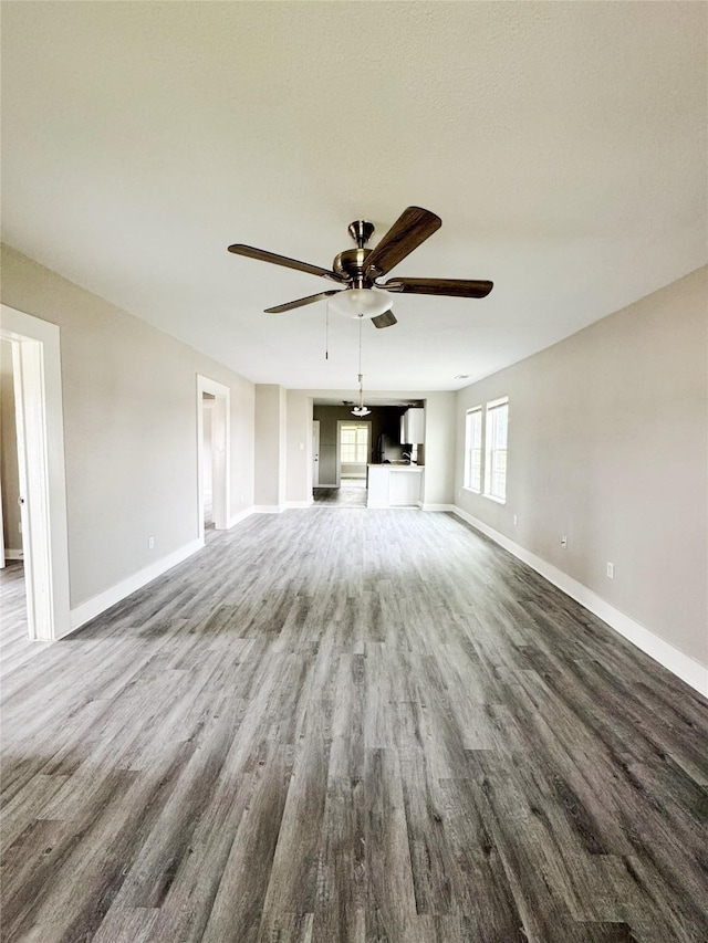 609 Martin Luther King Jr Blvd, Corsicana, TX 75110 - unfurnished living room with wood finished floors, ceiling fan, and baseboards