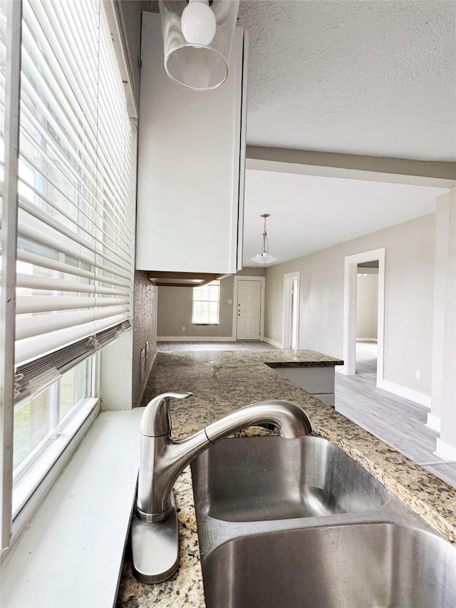 609 Martin Luther King Jr Blvd, Corsicana, TX 75110 - detailed view of a sink, baseboards, and wood finished floors