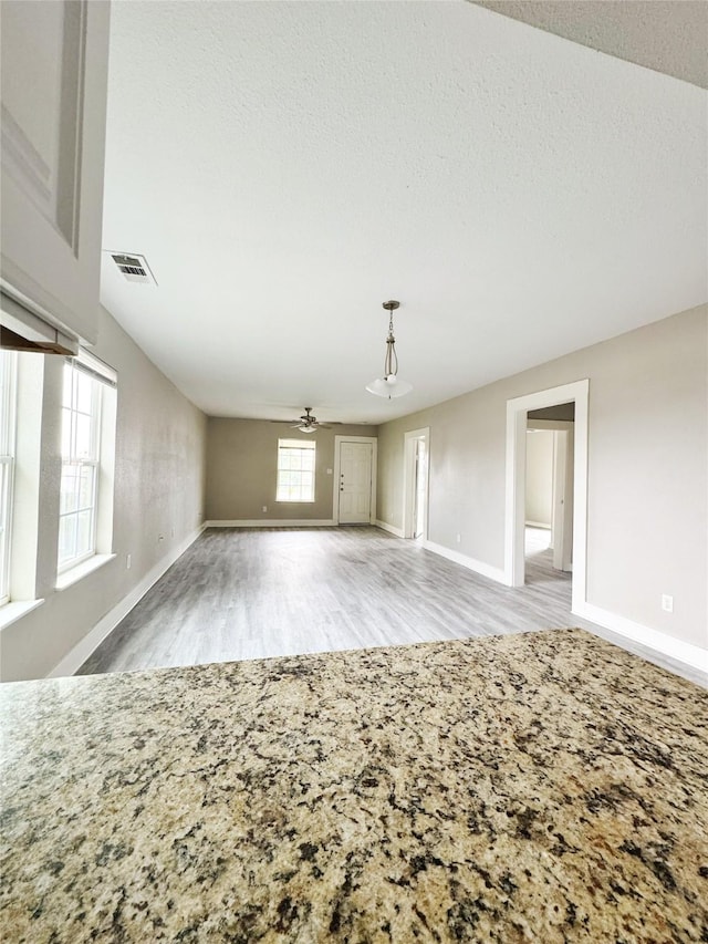 609 Martin Luther King Jr Blvd, Corsicana, TX 75110 - unfurnished living room with a ceiling fan, wood finished floors, and baseboards