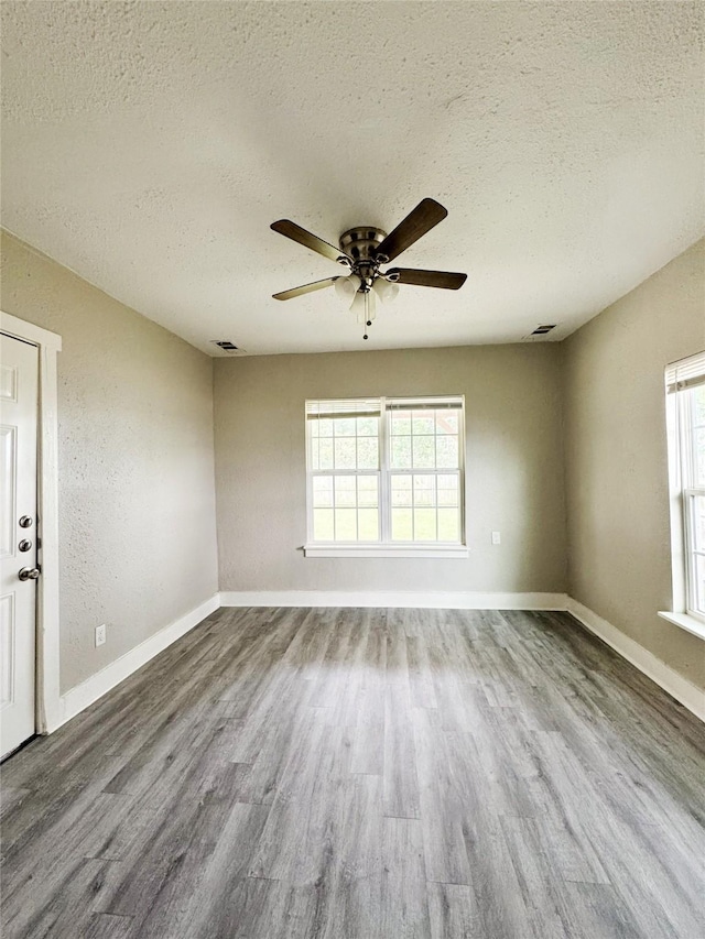 609 Martin Luther King Jr Blvd, Corsicana, TX 75110 - empty room featuring a textured ceiling, wood finished floors, ceiling fan, and baseboards