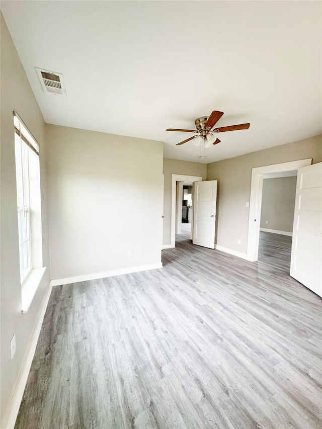 609 Martin Luther King Jr Blvd, Corsicana, TX 75110 - unfurnished living room with wood finished floors, baseboards, and a ceiling fan
