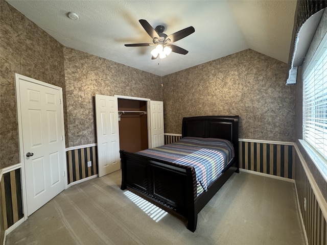 2406 Meadow Tree Ln, Spring, TX 77388 - bedroom with light colored carpet, vaulted ceiling, a closet, a textured ceiling, and ceiling fan