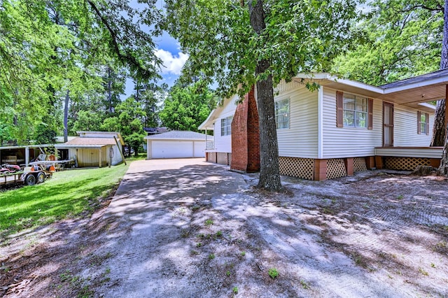 6 Hickory Holw, Huntsville, TX 77320 - view of side of home with an outbuilding, crawl space, a garage, and a lawn