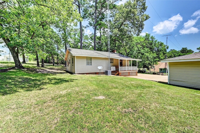 6 Hickory Holw, Huntsville, TX 77320 - back of house featuring a yard and cooling unit