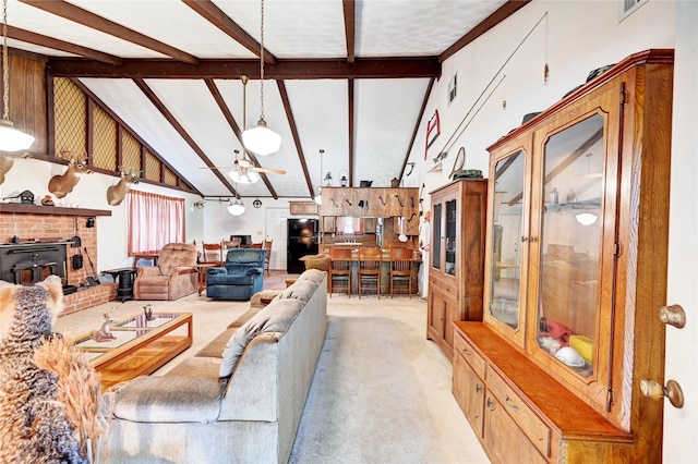 6 Hickory Holw, Huntsville, TX 77320 - living area featuring ceiling fan, light colored carpet, beam ceiling, a fireplace, and high vaulted ceiling