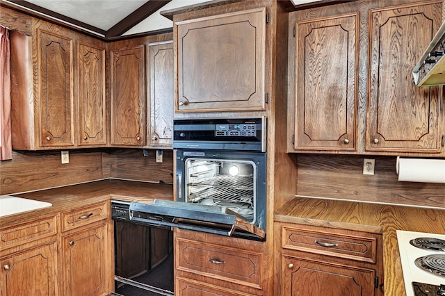 6 Hickory Holw, Huntsville, TX 77320 - kitchen featuring black appliances, brown cabinetry, and vaulted ceiling
