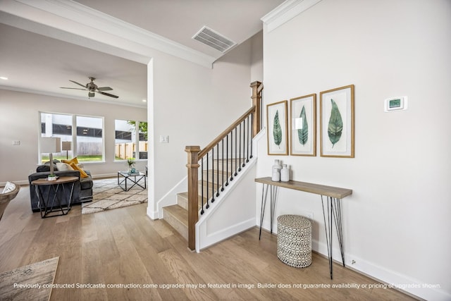 1816 Colquitt St, Houston, TX 77098 - staircase with crown molding, wood finished floors, a ceiling fan, baseboards, and recessed lighting