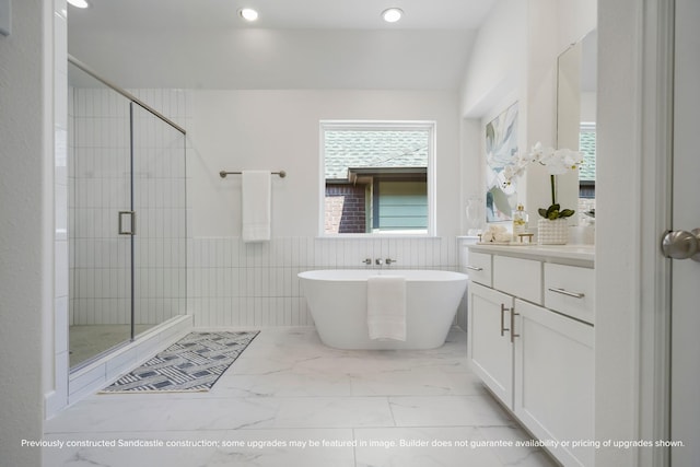 1816 Colquitt St, Houston, TX 77098 - full bathroom with a shower stall, a freestanding tub, tile walls, vanity, and marble finish floors