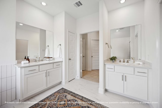 1816 Colquitt St, Houston, TX 77098 - bathroom featuring two vanities, marble finish floors, and recessed lighting