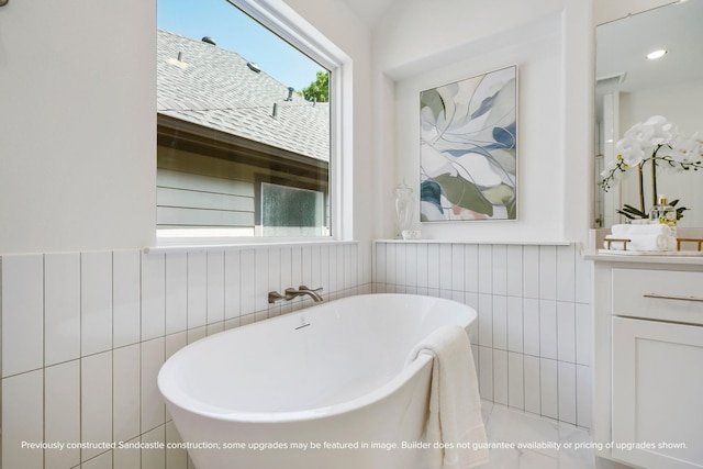 1816 Colquitt St, Houston, TX 77098 - full bath featuring a freestanding tub, tile walls, vanity, and wainscoting