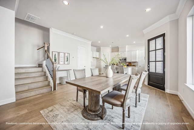 1816 Colquitt St, Houston, TX 77098 - dining room with ornamental molding, stairs, recessed lighting, light wood finished floors, and healthy amount of natural light