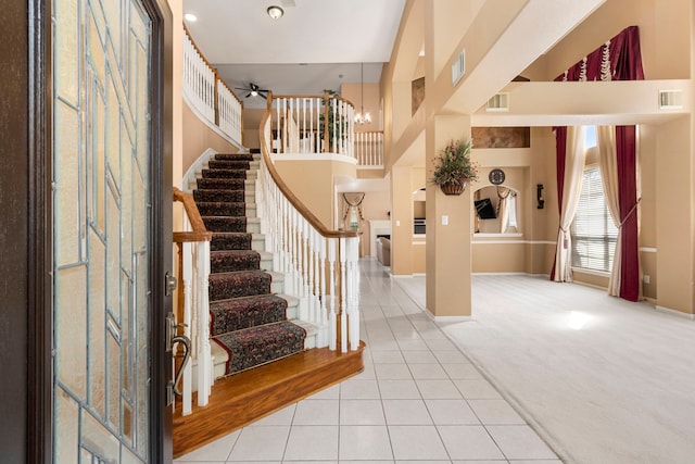 3915 Garnet Fls, Sugar Land, TX 77479 - carpeted foyer with tile patterned floors, stairs, a high ceiling, baseboards, and a ceiling fan