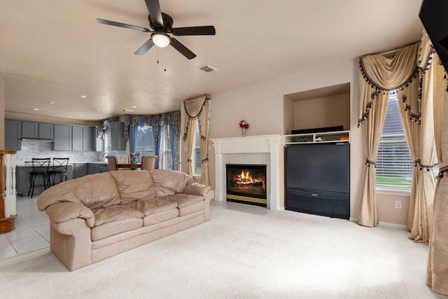 3915 Garnet Fls, Sugar Land, TX 77479 - living room with a ceiling fan, a tile fireplace, and light colored carpet