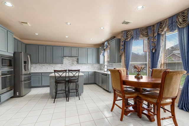 3915 Garnet Fls, Sugar Land, TX 77479 - kitchen featuring stainless steel appliances, a sink, a center island, gray cabinetry, and recessed lighting
