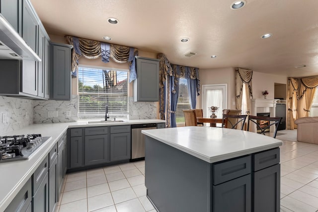 3915 Garnet Fls, Sugar Land, TX 77479 - kitchen with stainless steel appliances, a sink, gray cabinetry, wall chimney range hood, and recessed lighting