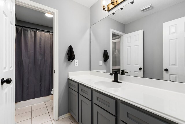 3915 Garnet Fls, Sugar Land, TX 77479 - full bath with toilet, vanity, tile patterned flooring, and curtained shower
