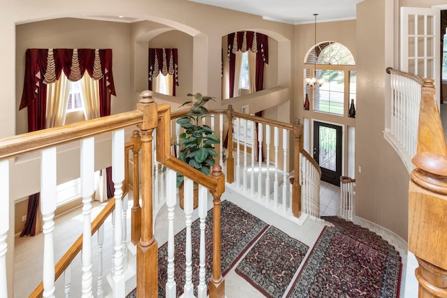 3915 Garnet Fls, Sugar Land, TX 77479 - entryway with a chandelier, crown molding, baseboards, stairs, and arched walkways