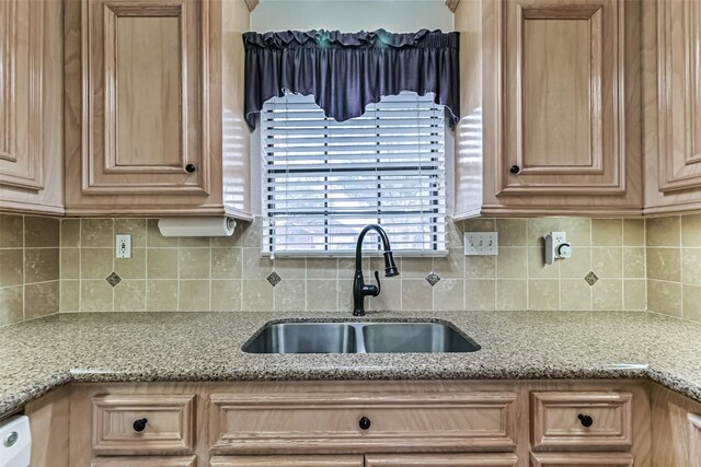404 Live Oak Ln, Friendswood, TX 77546 - kitchen featuring a sink, decorative backsplash, and light stone countertops