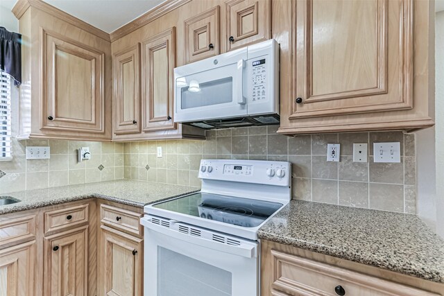 404 Live Oak Ln, Friendswood, TX 77546 - kitchen with white appliances, light brown cabinets, decorative backsplash, and light stone countertops