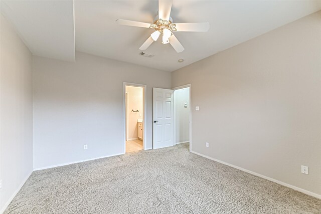 404 Live Oak Ln, Friendswood, TX 77546 - unfurnished bedroom featuring light carpet, baseboards, connected bathroom, and ceiling fan