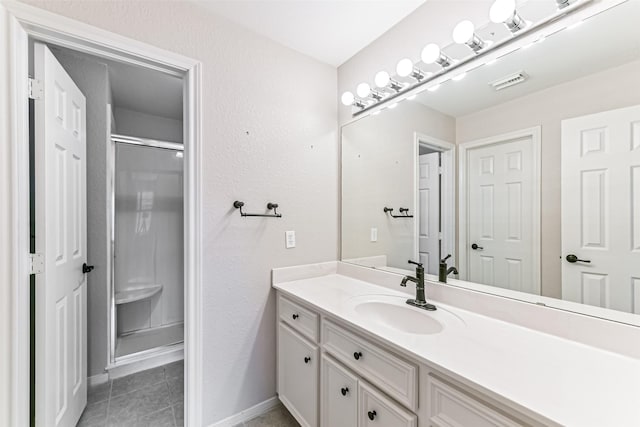 404 Live Oak Ln, Friendswood, TX 77546 - full bathroom featuring vanity, a stall shower, tile patterned flooring, and baseboards