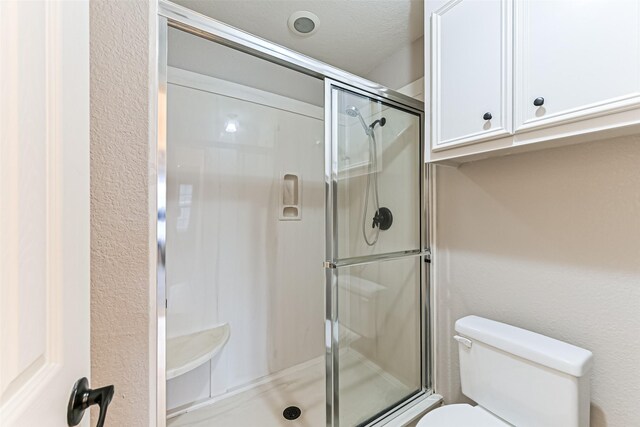 404 Live Oak Ln, Friendswood, TX 77546 - bathroom featuring toilet and a stall shower