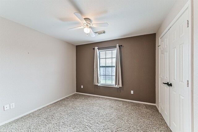 404 Live Oak Ln, Friendswood, TX 77546 - unfurnished bedroom featuring a closet, carpet floors, baseboards, and ceiling fan