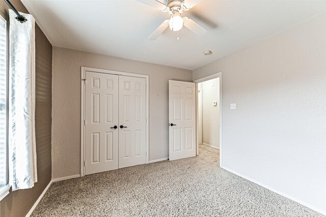 404 Live Oak Ln, Friendswood, TX 77546 - unfurnished bedroom with a closet, baseboards, carpet, and a ceiling fan
