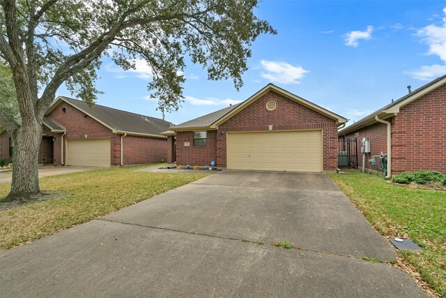 404 Live Oak Ln, Friendswood, TX 77546 - view of front of house with brick siding, a front yard, a garage, and concrete driveway