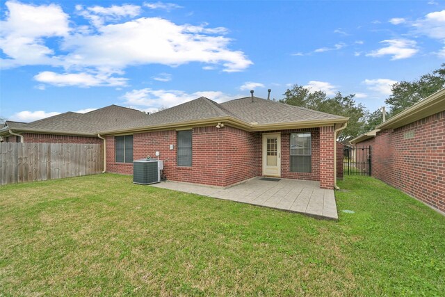 404 Live Oak Ln, Friendswood, TX 77546 - back of house with central AC unit, brick siding, a shingled roof, and a patio