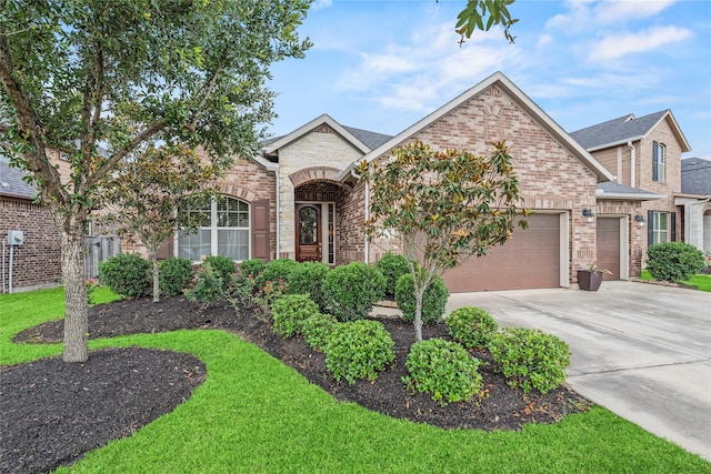18810 Peachleaf Willow Trce, Cypress, TX 77429 - view of front of home featuring a garage, concrete driveway, brick siding, a shingled roof, and stone siding