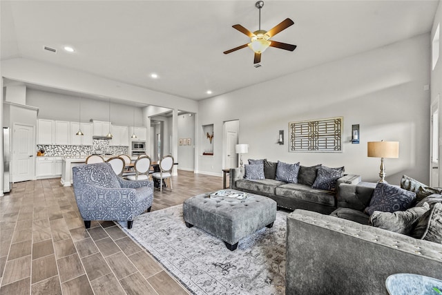 18810 Peachleaf Willow Trce, Cypress, TX 77429 - living area featuring ceiling fan, recessed lighting, vaulted ceiling, and wood finished floors