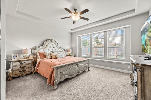 18810 Peachleaf Willow Trce, Cypress, TX 77429 - bedroom featuring a raised ceiling, carpet, baseboards, and ceiling fan