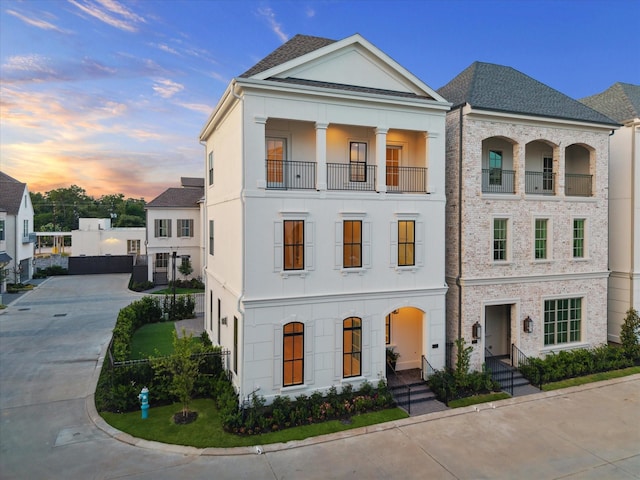 213 Sutton Row Pl, Houston, TX 77024 - view of front of home with a balcony, stucco siding, and concrete driveway